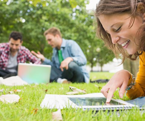 students-studying-with-labtops-in-park