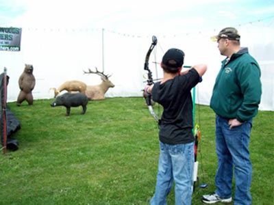 youth-shooting-bow-with-advisor